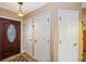 Bright foyer featuring tiled floor, front door with decorative glass, and white paneled closet doors at 3123 David St, Punta Gorda, FL 33982