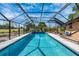 Large screened-in pool with crystal blue water perfect for year-round swimming and relaxation at 3123 David St, Punta Gorda, FL 33982