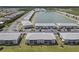 Aerial view of a condo community, featuring lush lawns, mature trees, ample parking, and a serene lake at 3310 Loveland Blvd # 1102, Punta Gorda, FL 33980