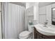 Bathroom features a shower with white curtain, toilet, and vanity sink with storage cabinet at 3310 Loveland Blvd # 1102, Punta Gorda, FL 33980