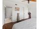 The bedroom includes wood-look floors, a ceiling fan, and access to a bathroom and closets at 3310 Loveland Blvd # 1102, Punta Gorda, FL 33980