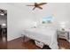 Bright bedroom features a ceiling fan, wood-look flooring, and a window with a view of the outside at 3310 Loveland Blvd # 1102, Punta Gorda, FL 33980