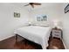This bedroom includes wood-look floors, a ceiling fan, and a window with a view of the outside at 3310 Loveland Blvd # 1102, Punta Gorda, FL 33980