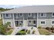 Two-story condo building featuring well-maintained landscaping and convenient access to each unit at 3310 Loveland Blvd # 1102, Punta Gorda, FL 33980