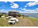 Community gazebo with picnic tables and barbecue, perfect for outdoor gatherings by the lake at 3310 Loveland Blvd # 1102, Punta Gorda, FL 33980