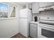 Bright kitchen features white appliances, ample cabinet space, and a convenient layout for cooking at 3310 Loveland Blvd # 1102, Punta Gorda, FL 33980