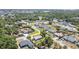 Aerial view of the property showcasing its location in a serene residential neighborhood with lush greenery and nearby waterways at 402 Cicero Nw St, Port Charlotte, FL 33948