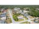 Aerial view of home in a suburban neighborhood, with a well-maintained lawn and tree-lined property at 402 Cicero Nw St, Port Charlotte, FL 33948