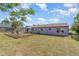 A purple home is featured in this large fenced backyard at 402 Cicero Nw St, Port Charlotte, FL 33948