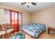 This bedroom features a window, chair, and patterned rug on the tile floor at 402 Cicero Nw St, Port Charlotte, FL 33948