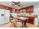 Spacious kitchen with rich wood cabinetry, a marble-top island, and modern appliances at 402 Cicero Nw St, Port Charlotte, FL 33948