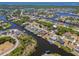 Stunning aerial view of waterfront homes along canals in a picturesque coastal community with mature trees and blue skies at 4146 Library St, Port Charlotte, FL 33948