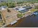Aerial view of waterfront property featuring a screened-in pool, private dock, and scenic canal access at 4146 Library St, Port Charlotte, FL 33948