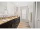 Bathroom featuring dual sinks with granite countertops, dark wood cabinetry, and modern fixtures at 4146 Library St, Port Charlotte, FL 33948
