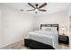 Bedroom with a dark bedframe, ceiling fan, and neutral colored walls at 4146 Library St, Port Charlotte, FL 33948