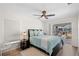 Bedroom with a ceiling fan and sliding doors to a screened in patio at 4146 Library St, Port Charlotte, FL 33948