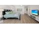 Bright bedroom with a large bed, light colored walls and floors, and a modern media center at 4146 Library St, Port Charlotte, FL 33948