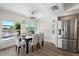 Dining room with table, chairs, stainless refrigerator, and views of the water at 4146 Library St, Port Charlotte, FL 33948