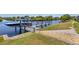 Dock with boat lift on a scenic canal offering easy access to the water for boating and recreation at 4146 Library St, Port Charlotte, FL 33948