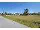 Charming home with a spacious yard, complemented by mature palm trees and well-maintained landscaping at 4146 Library St, Port Charlotte, FL 33948
