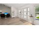 Inviting foyer with light wood floors, a decorative table, and plenty of natural light streaming through the windows at 4146 Library St, Port Charlotte, FL 33948