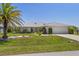Well-maintained home with lush landscaping, a manicured lawn, and an attached two-car garage providing excellent curb appeal at 4146 Library St, Port Charlotte, FL 33948