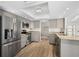 Updated kitchen with stainless steel appliances, gray cabinetry, granite countertops, and modern lighting fixtures at 4146 Library St, Port Charlotte, FL 33948