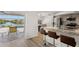 Open kitchen with bar seating, granite countertops, stainless steel appliances, and access to the outdoor patio at 4146 Library St, Port Charlotte, FL 33948