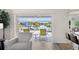 Bright living room with chair seating overlooking a tranquil waterway view through sliding glass doors at 4146 Library St, Port Charlotte, FL 33948