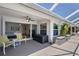 Covered outdoor patio with seating and access to the main bedroom and pool at 4146 Library St, Port Charlotte, FL 33948