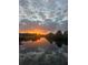 Gorgeous sunset reflecting on tranquil water with beautiful clouds creating a serene and picturesque scene at 4146 Library St, Port Charlotte, FL 33948