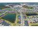 An aerial view showcases the community with a large lake and well-spaced homes at 43839 Seedling Ter, Punta Gorda, FL 33982