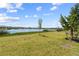 Serene backyard featuring a lush lawn and picturesque views of a tranquil lake at 43839 Seedling Ter, Punta Gorda, FL 33982