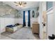 bedroom with surfboard decor, a bed and blue accent wall with wave wallpaper at 43839 Seedling Ter, Punta Gorda, FL 33982