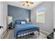 Cozy bedroom featuring a blue accent wall, a full size bed, and soft natural light at 43839 Seedling Ter, Punta Gorda, FL 33982