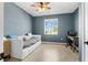 Cozy bedroom with blue walls, a daybed, and a window offering natural light at 43839 Seedling Ter, Punta Gorda, FL 33982