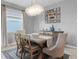 Cozy dining area with modern chandelier and a wooden table with seating for six, creating an inviting atmosphere at 43839 Seedling Ter, Punta Gorda, FL 33982