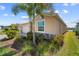 View of exterior with neat landscaping, a well-maintained lawn, and charming stone accents at 43839 Seedling Ter, Punta Gorda, FL 33982