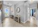 Bright entryway with tile flooring, a decorative table, and an accent mirror at 43839 Seedling Ter, Punta Gorda, FL 33982