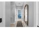 Hallway with doors leading to bedrooms and a decorative mirror on the wall at 43839 Seedling Ter, Punta Gorda, FL 33982
