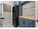 Modern laundry room featuring stacked washer and dryer units and butcher block folding counter at 43839 Seedling Ter, Punta Gorda, FL 33982
