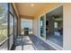 Covered patio with a barbecue grill and sliding glass doors leading into the living area at 43839 Seedling Ter, Punta Gorda, FL 33982