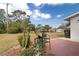 Spacious backyard with brick patio, shade trees and beautiful lawn at 5179 Grobe St, North Port, FL 34287