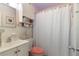 Bright bathroom with white cabinets, fish decoration, and a framed picture above the toilet at 5179 Grobe St, North Port, FL 34287