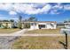 Charming single story home featuring a front lawn and a white exterior, complemented by a covered carport at 5179 Grobe St, North Port, FL 34287