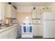 Well-lit kitchen featuring essential appliances and functional cabinet storage space at 5179 Grobe St, North Port, FL 34287