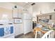 Open kitchen with major appliances, a ceiling fan, and adjacent dining and living area at 5179 Grobe St, North Port, FL 34287