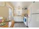 Functional kitchen with white cabinets, laminate countertops, and an adjacent dining area at 5179 Grobe St, North Port, FL 34287