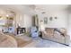 Inviting living room with ceiling fan, comfortable seating, and a smooth transition into the adjacent kitchen at 5179 Grobe St, North Port, FL 34287