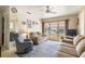 Bright living room with large window, comfortable seating, and a ceiling fan at 5179 Grobe St, North Port, FL 34287